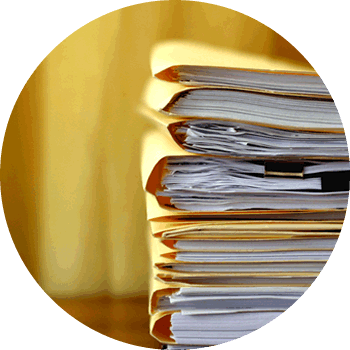 pile of yellow paper foldes with paper documents inside